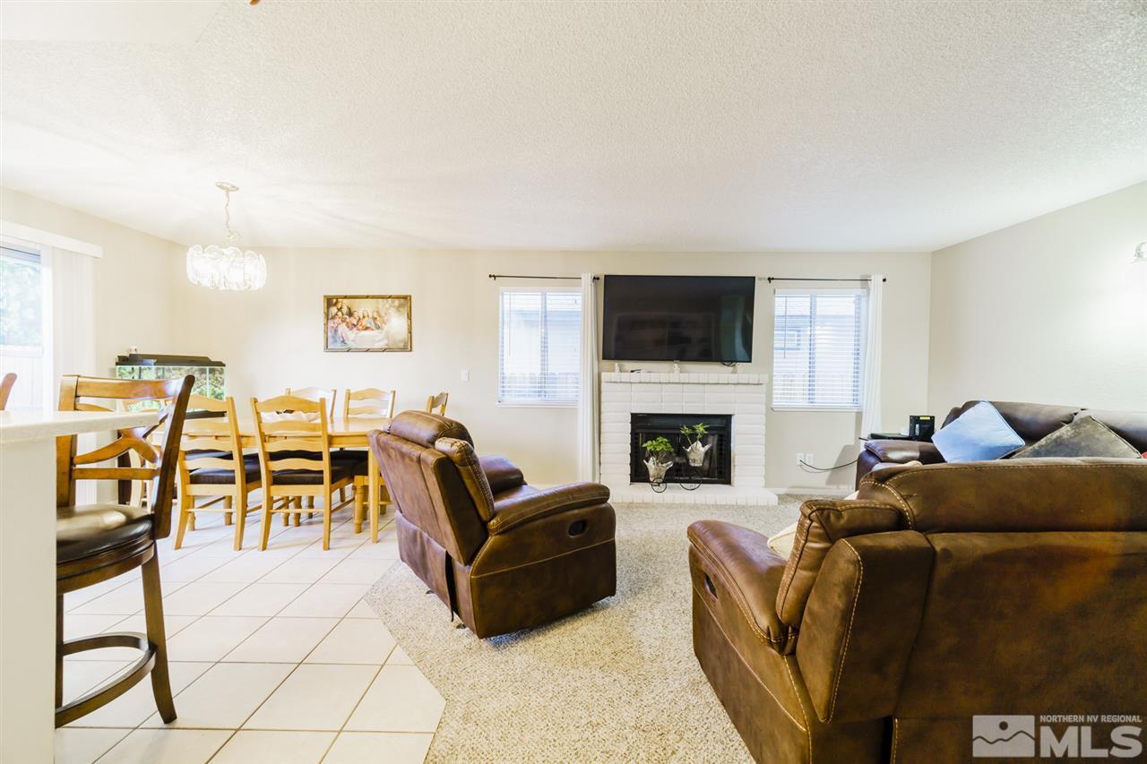 4275 Perro Lane Reno, NV 89502 - Photo 10 of 32 a living room with furniture a fireplace and a flat screen tv