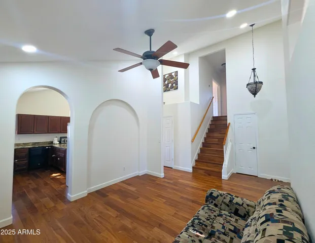 a view of a livingroom with furniture and hardwood floor