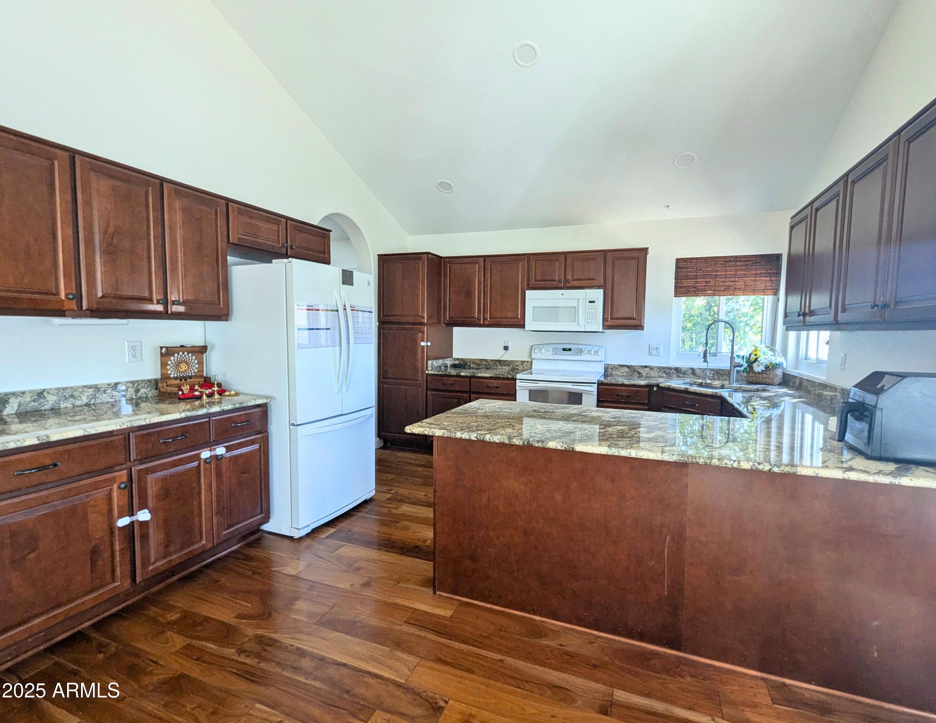242 South Sycamore Place Chandler, AZ 85224 - Photo 14 of 40 a kitchen with stainless steel appliances granite countertop a refrigerator a stove top oven a sink and dishwasher with wooden floor
