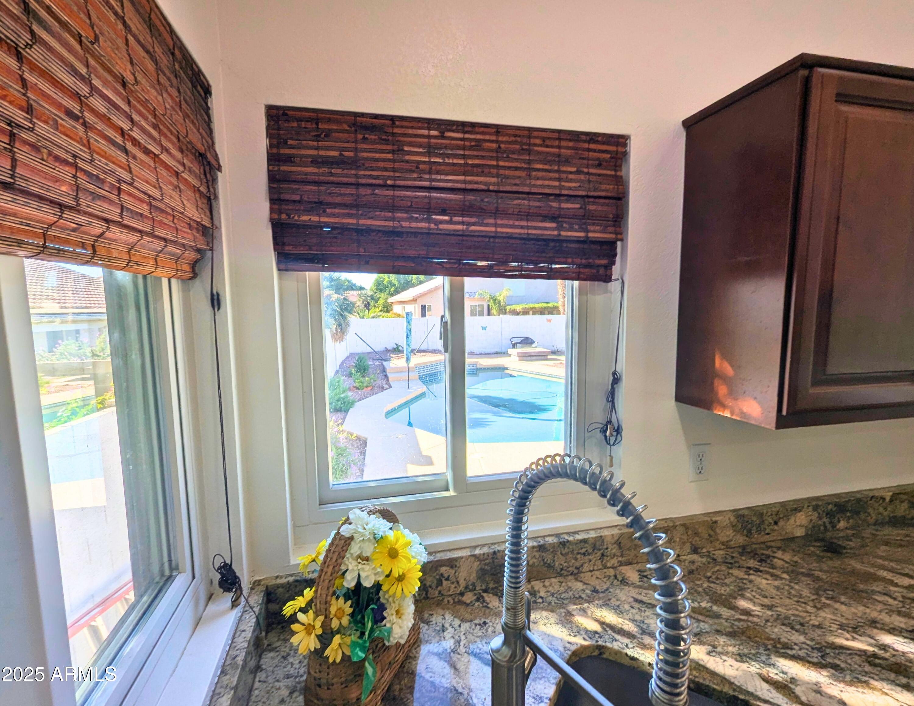242 South Sycamore Place Chandler, AZ 85224 - Photo 15 of 40 a view of a kitchen with a large window and a potted plant