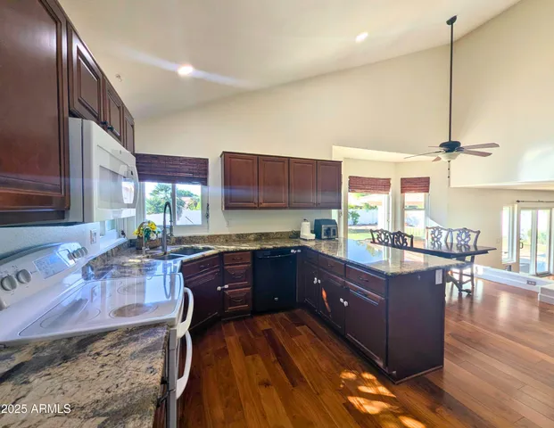 a view of a kitchen with a large window and a potted plant