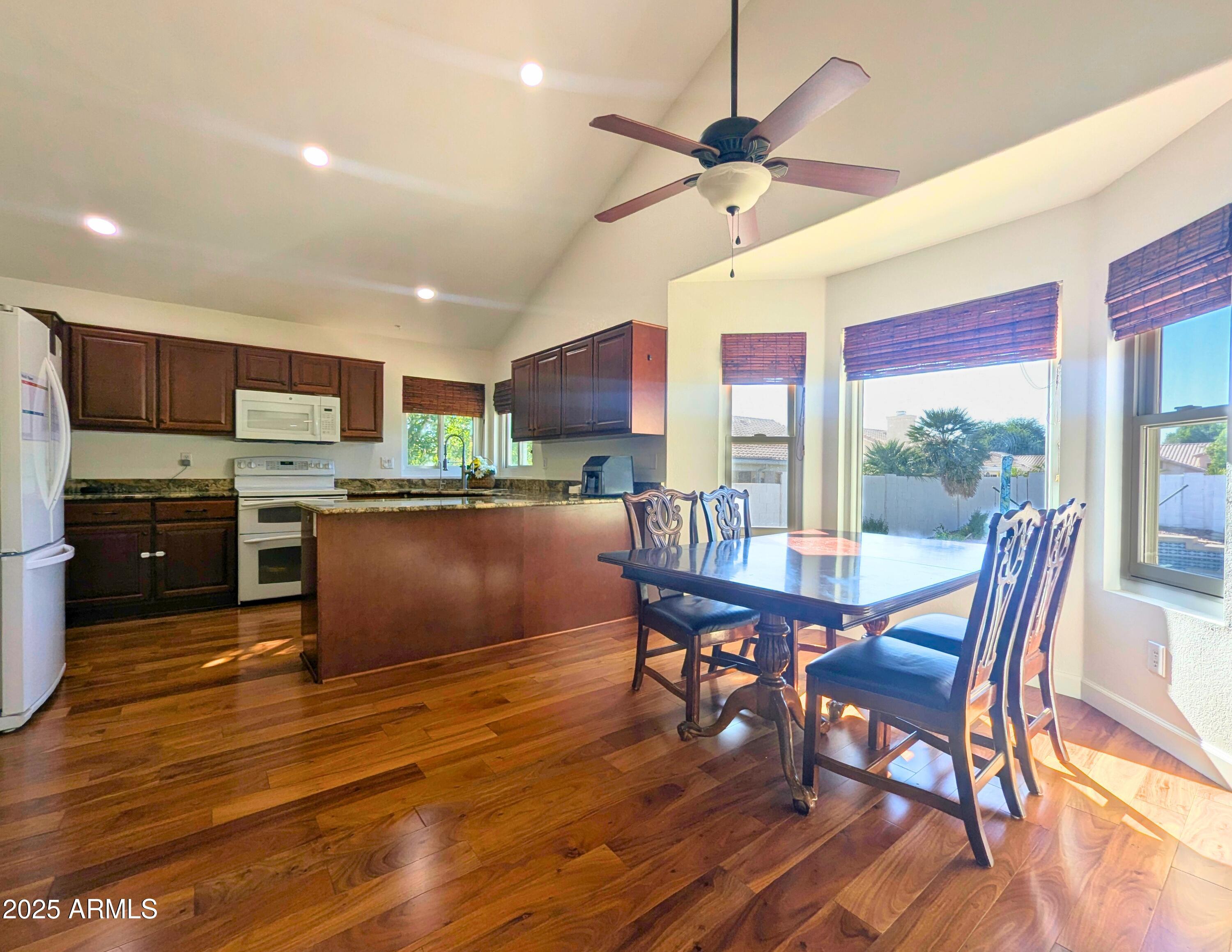 242 South Sycamore Place Chandler, AZ 85224 - Photo 17 of 40 a kitchen with a table chairs refrigerator and cabinets
