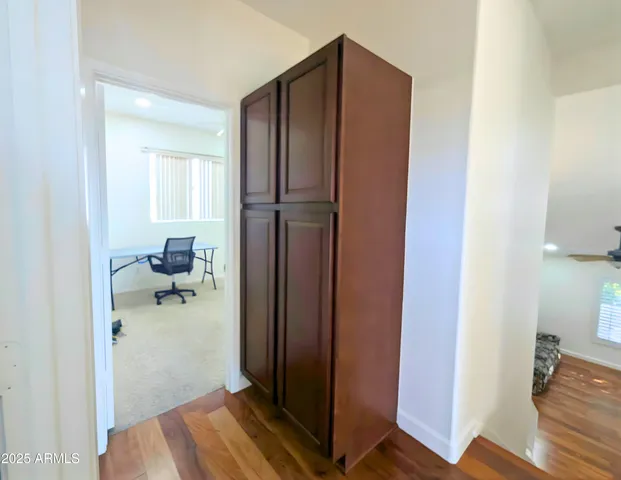 a view of empty room with wooden floor and fireplace