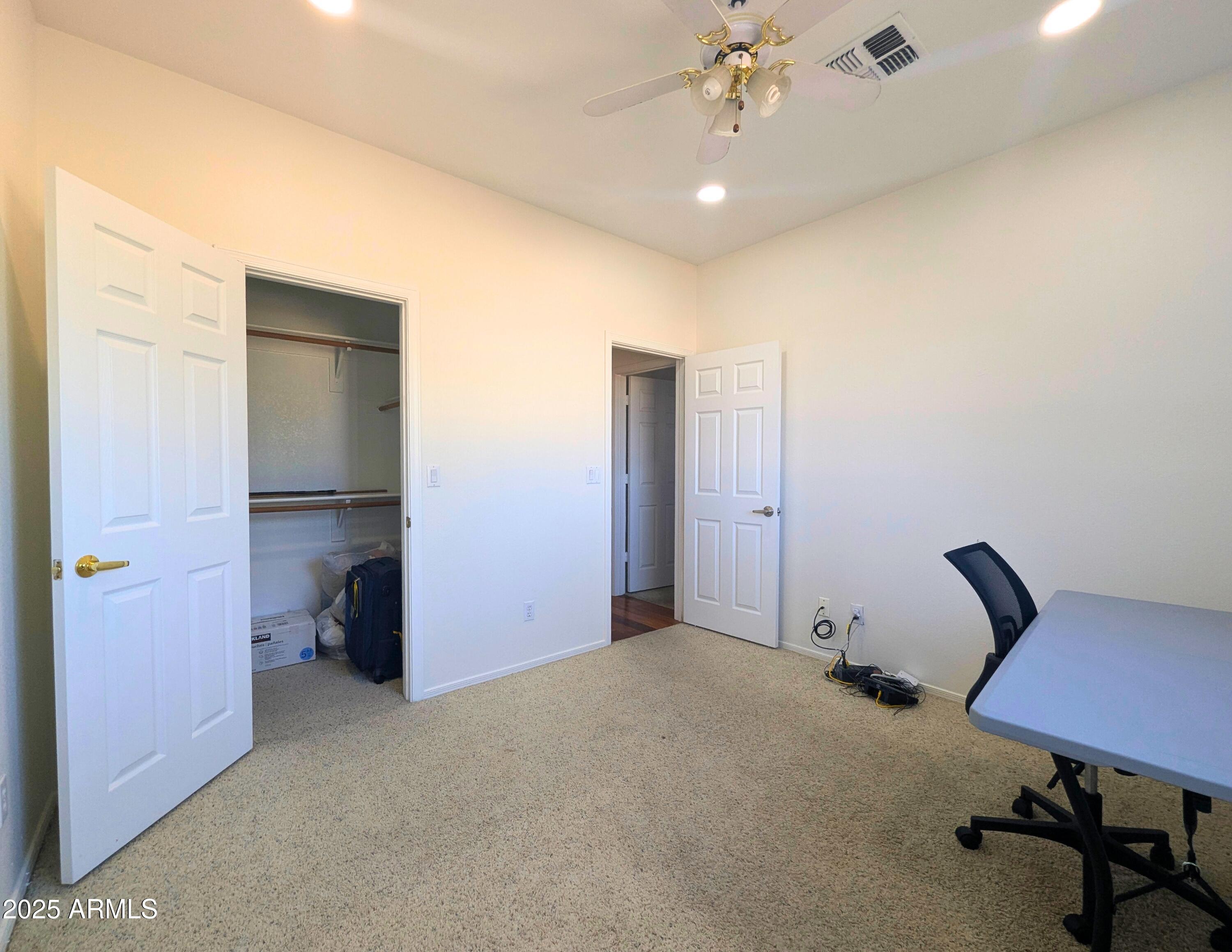 242 South Sycamore Place Chandler, AZ 85224 - Photo 28 of 40 a view of a livingroom with a chair and a ceiling fan