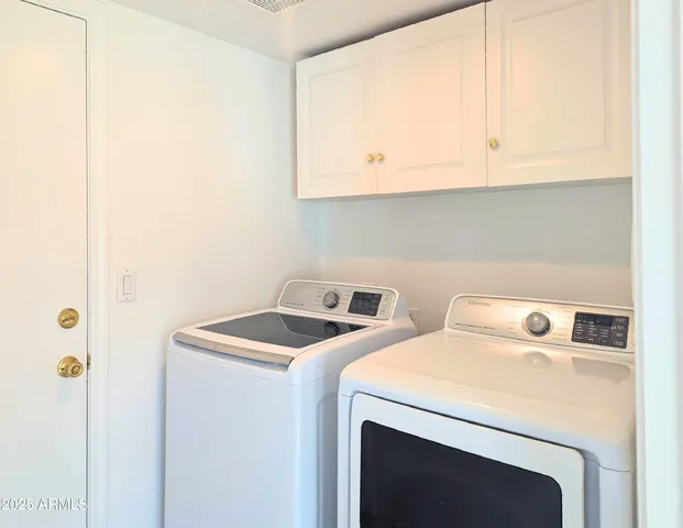 a view of a livingroom with a chair and a ceiling fan
