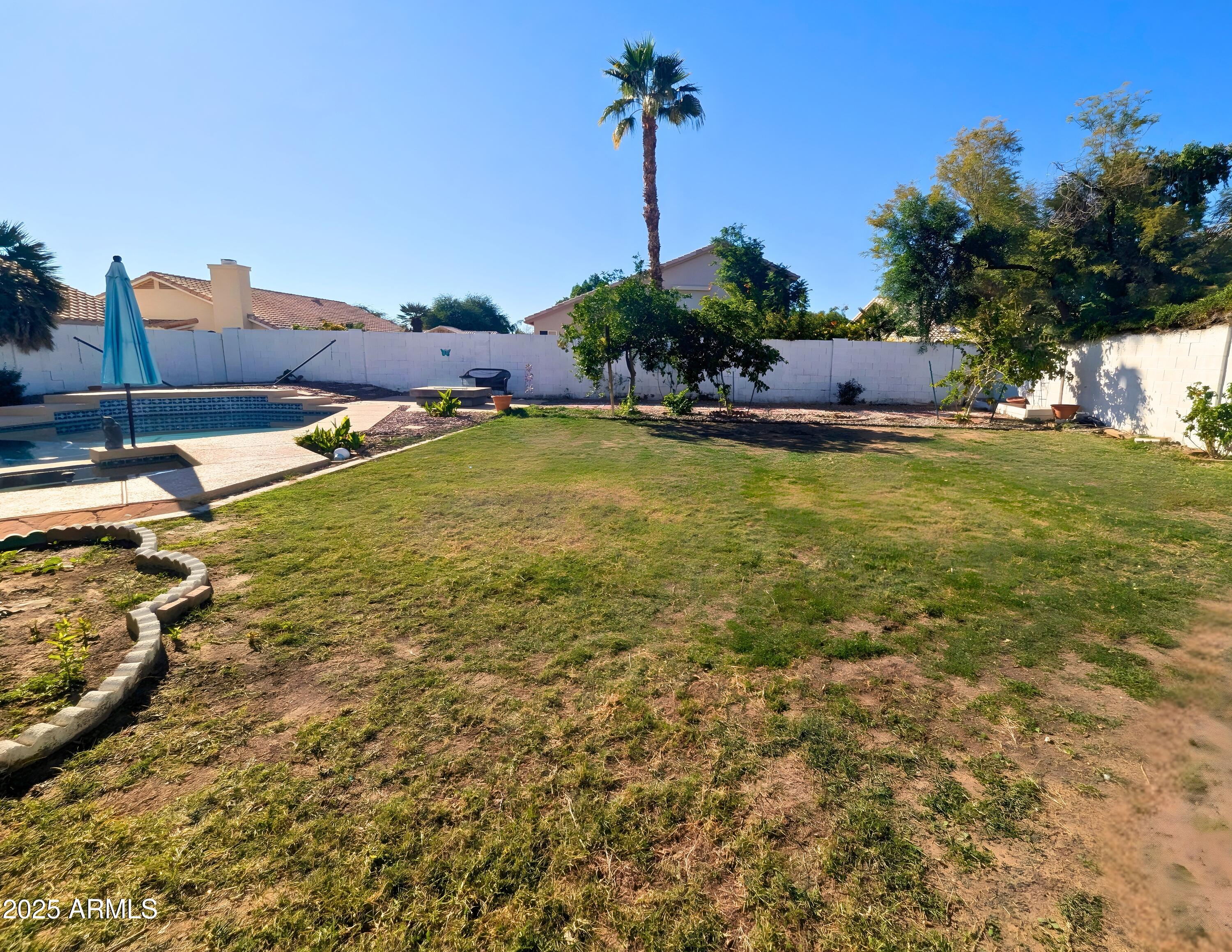 242 South Sycamore Place Chandler, AZ 85224 - Photo 32 of 40 a swimming pool with outdoor seating and yard