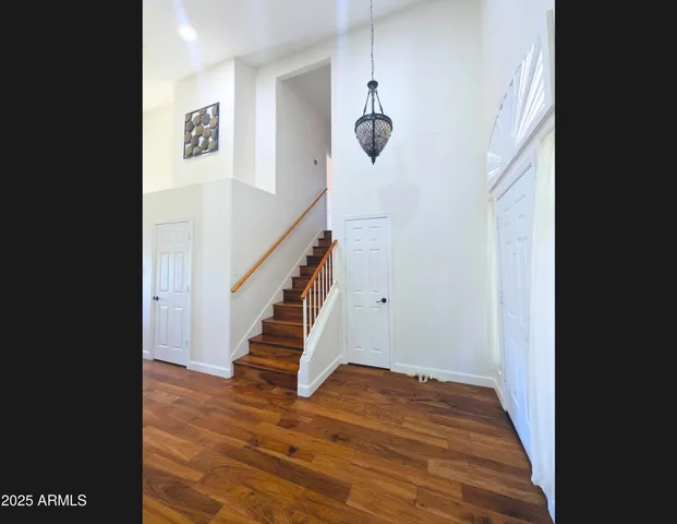 a view of entryway and hall with wooden floor