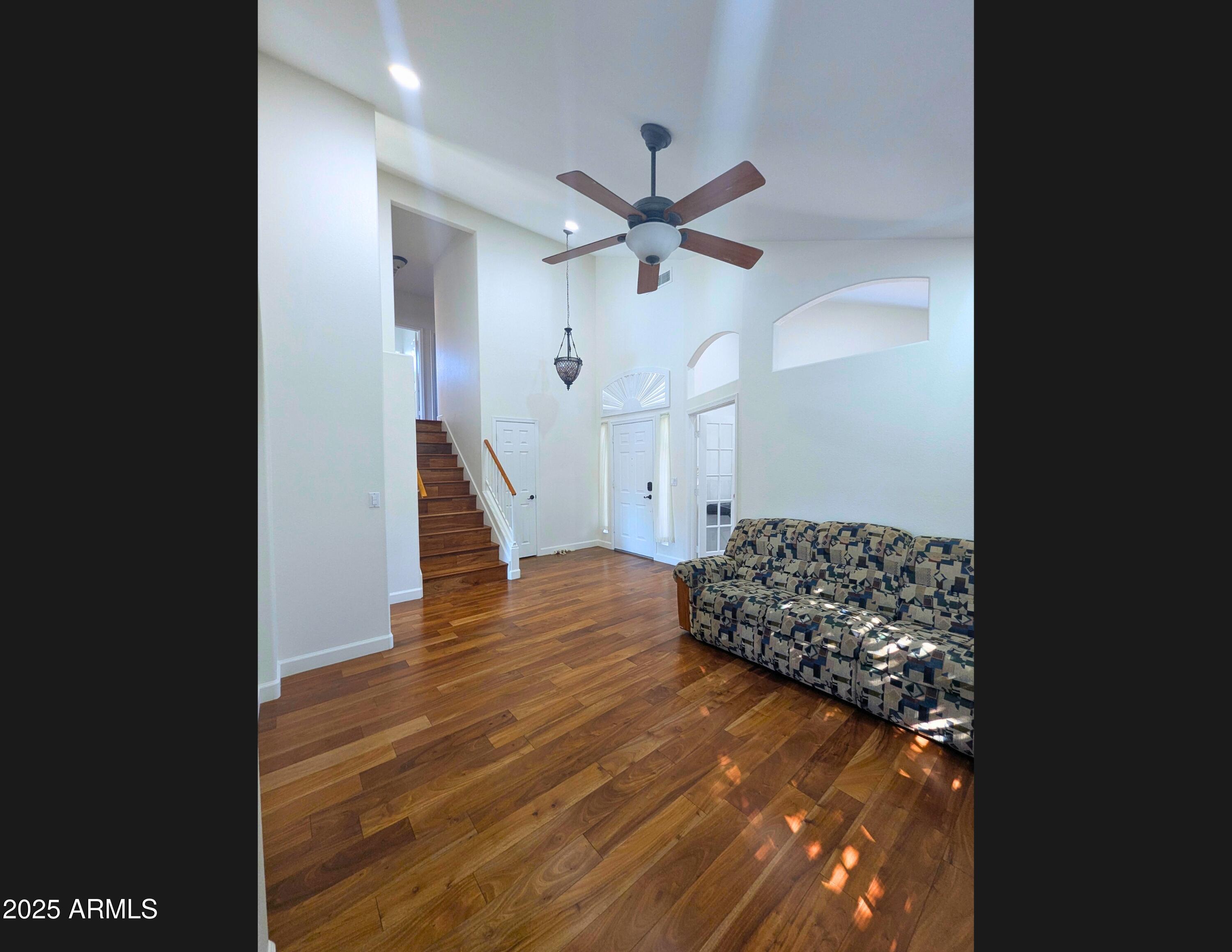 242 South Sycamore Place Chandler, AZ 85224 - Photo 9 of 40 a view of a livingroom with wooden floor a ceiling fan and window