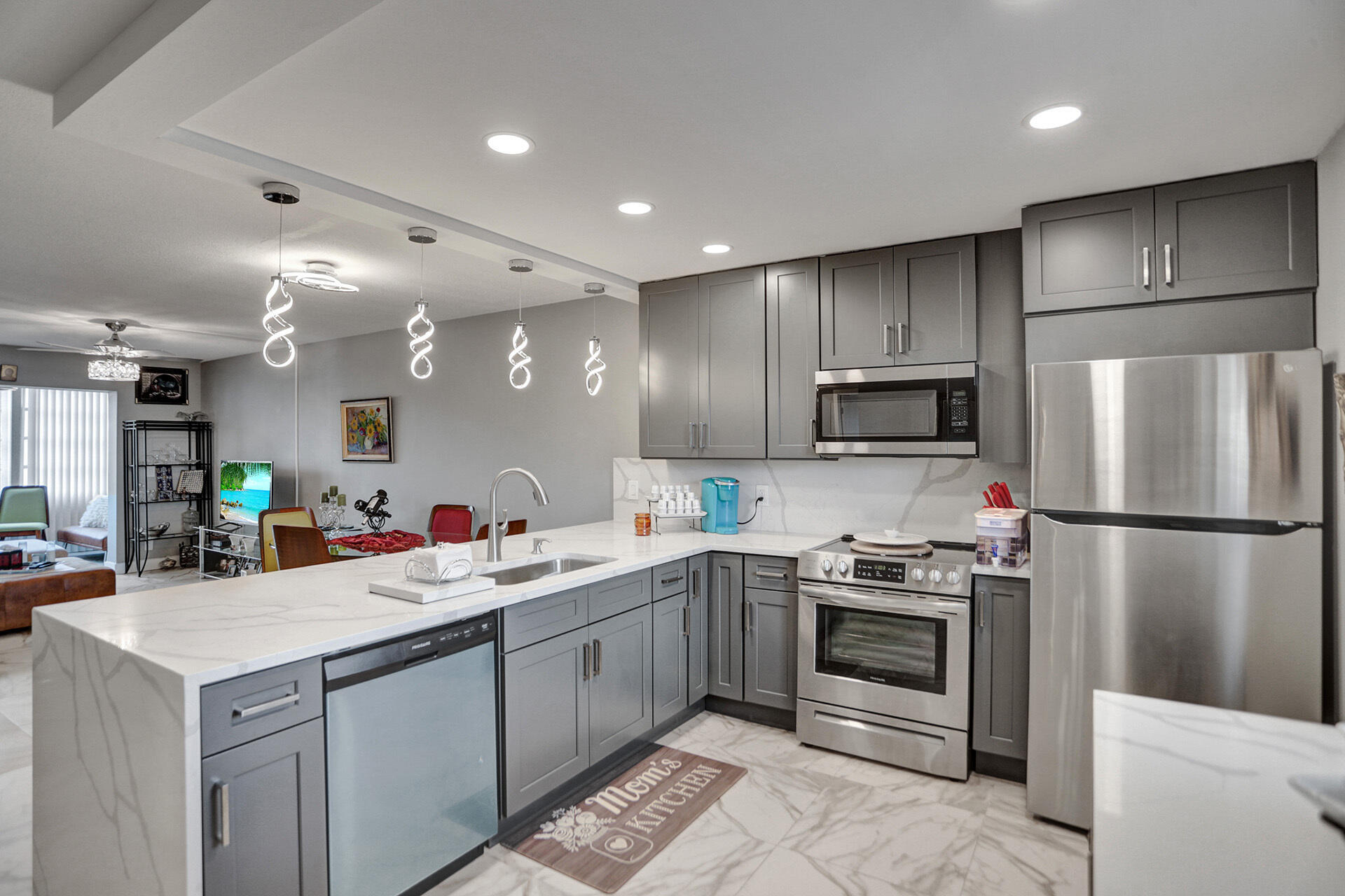 a kitchen with a sink stainless steel appliances and white cabinets