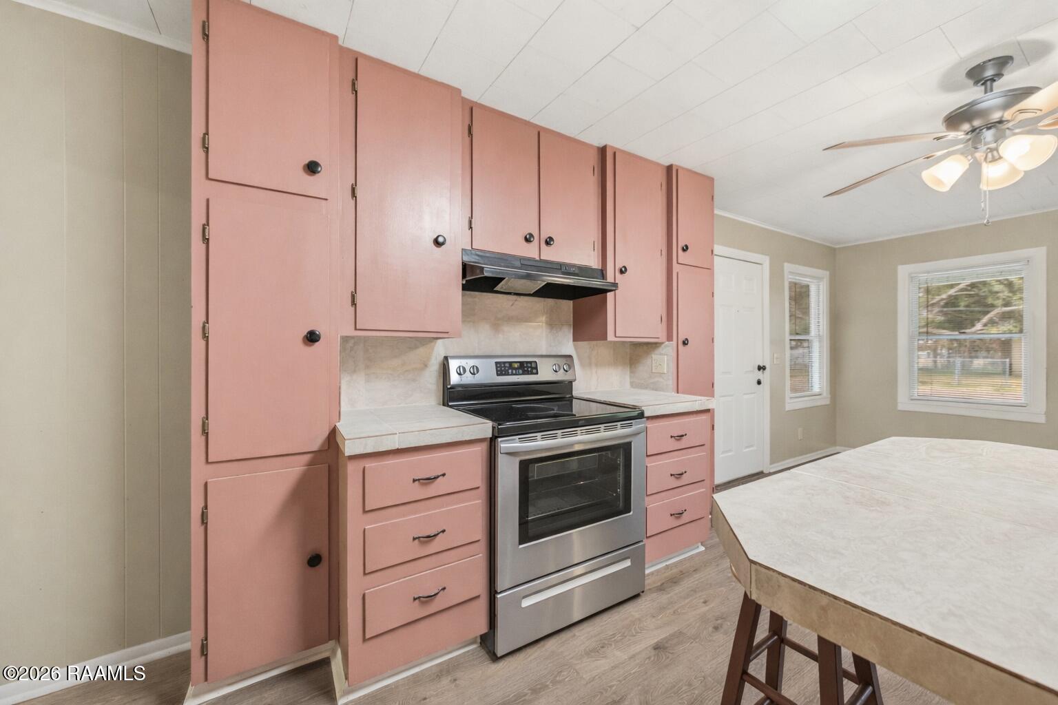 311 South Coolidge Street Church Point, LA 70525 - Photo 5 of 29 Cozy kitchen with coral cabinets and ove