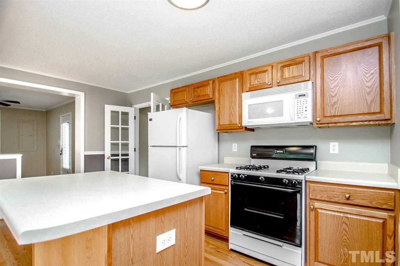 736 Mial Street Raleigh, NC 27608 - Photo 11 of 23 a kitchen with stainless steel appliances a stove a microwave and a refrigerator