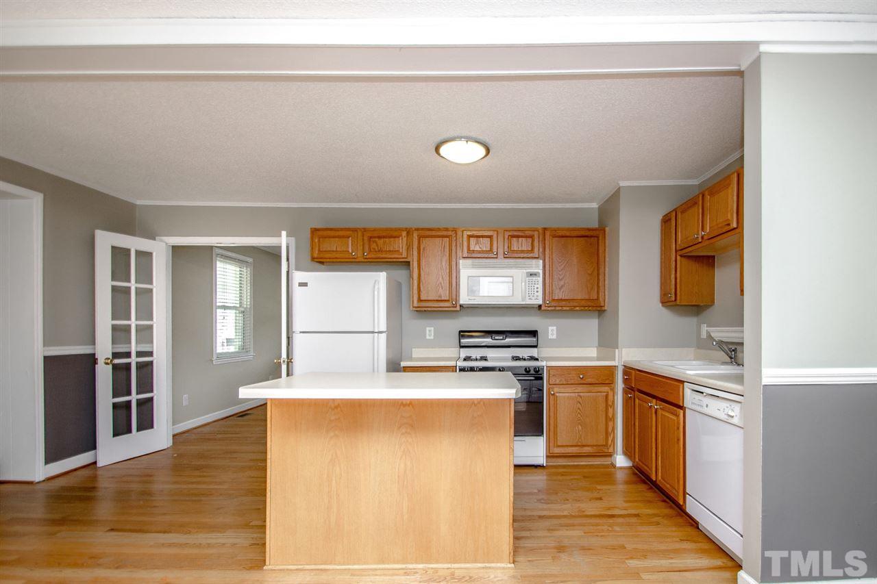 736 Mial Street Raleigh, NC 27608 - Photo 14 of 23 a kitchen with stainless steel appliances granite countertop a stove a sink and a refrigerator