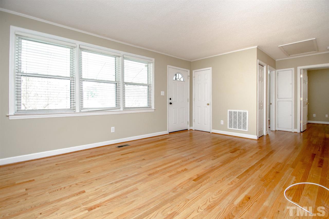 736 Mial Street Raleigh, NC 27608 - Photo 16 of 23 an empty room with wooden floor and windows