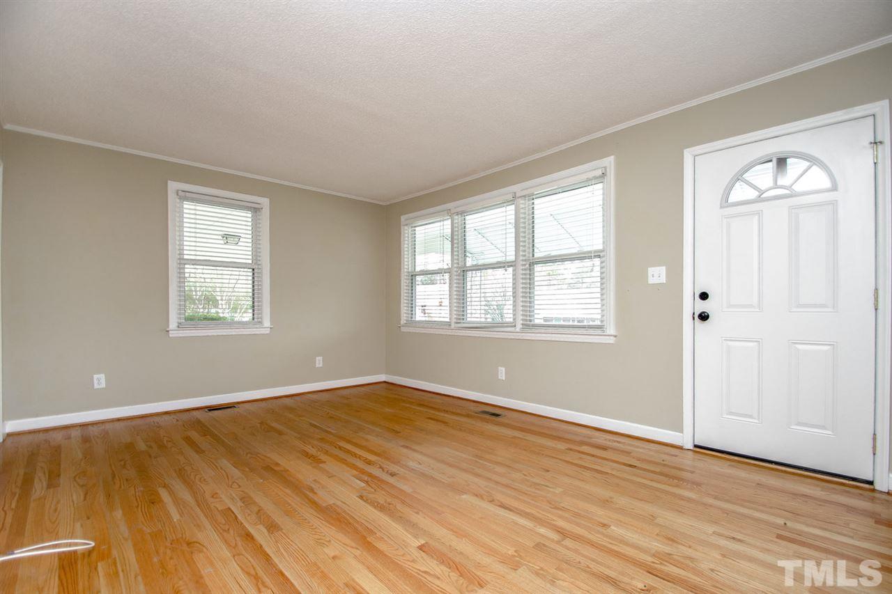 736 Mial Street Raleigh, NC 27608 - Photo 17 of 23 a view of an empty room with wooden floor and a window