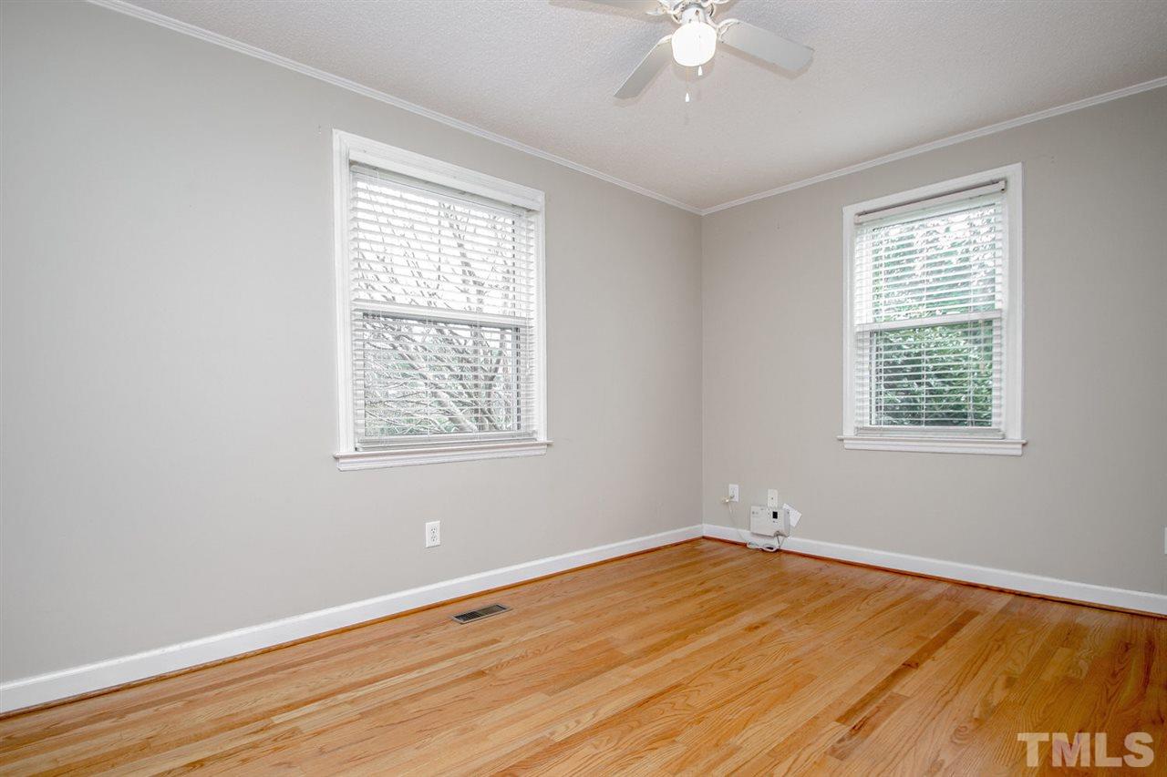 736 Mial Street Raleigh, NC 27608 - Photo 18 of 23 a view of an empty room with wooden floor and a window