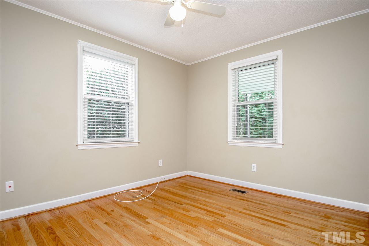 736 Mial Street Raleigh, NC 27608 - Photo 19 of 23 a view of an empty room with wooden floor and a window