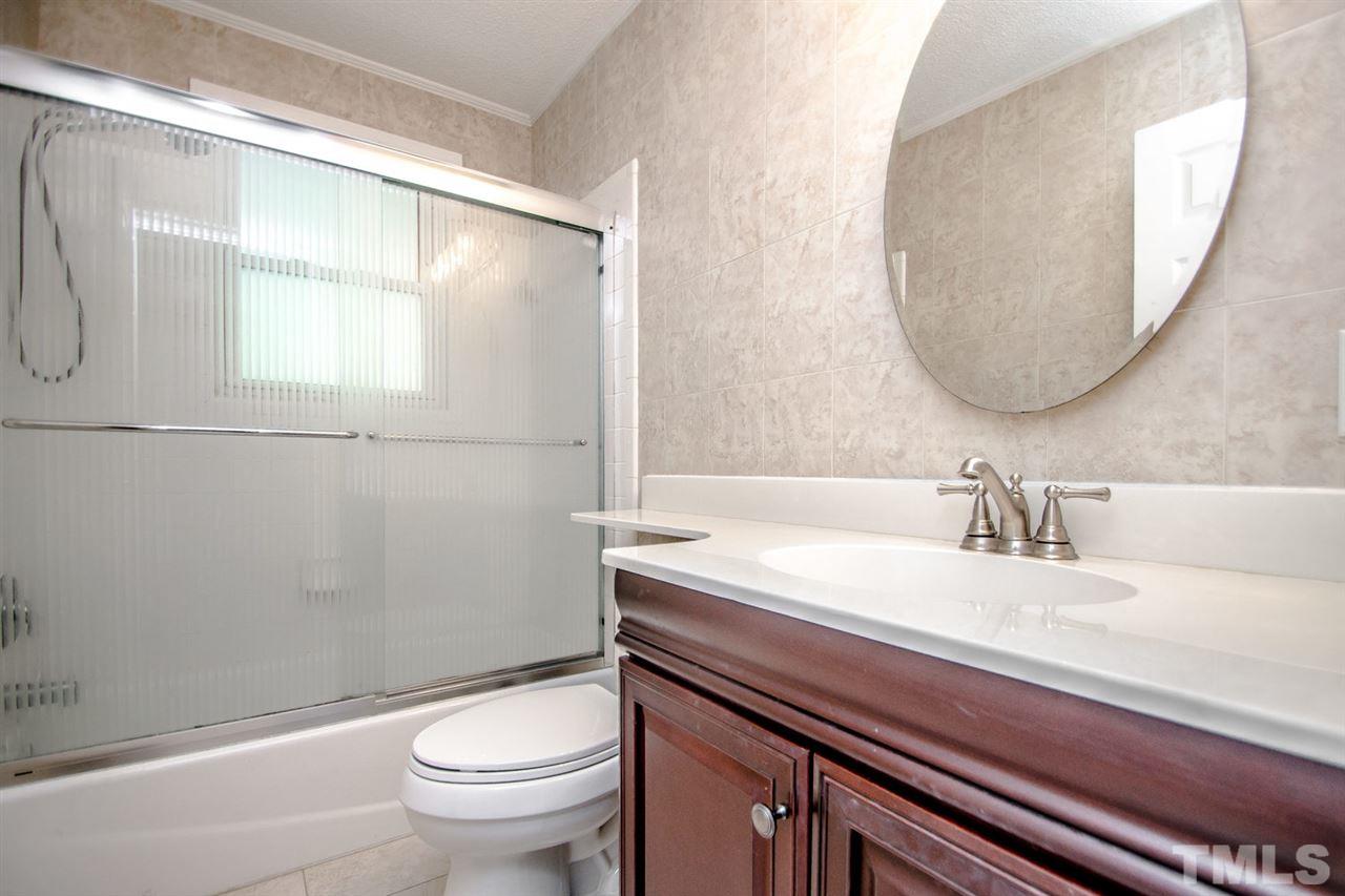 736 Mial Street Raleigh, NC 27608 - Photo 20 of 23 a bathroom with a sink a toilet and a mirror