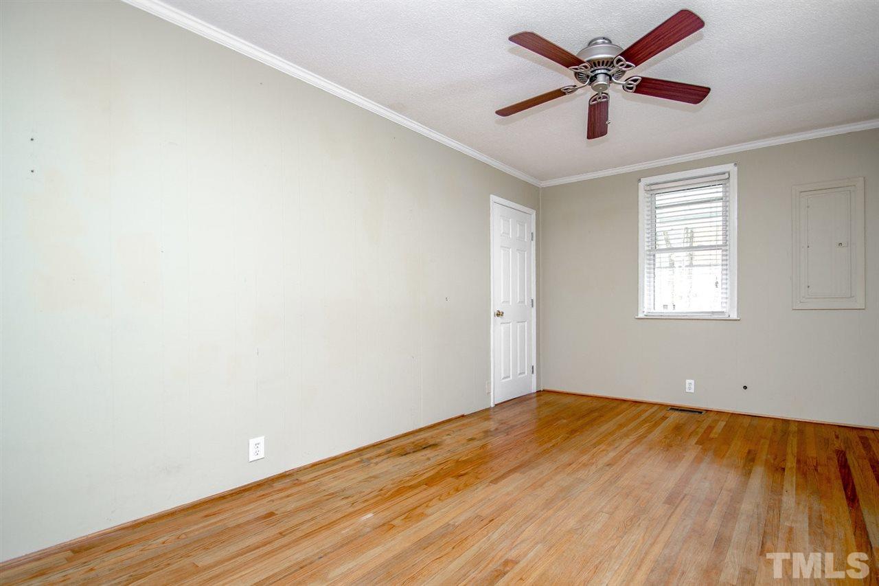 736 Mial Street Raleigh, NC 27608 - Photo 4 of 23 an empty room with wooden floor and windows