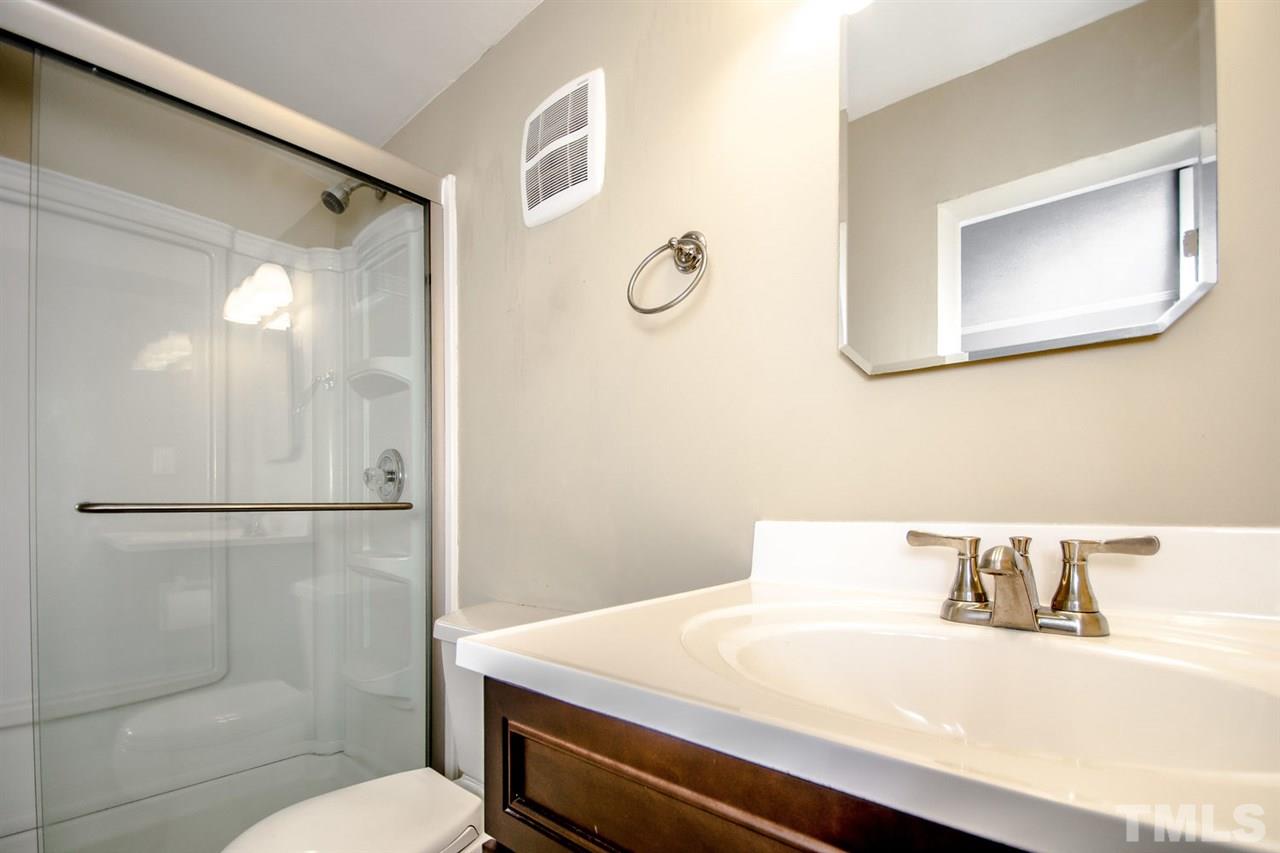 736 Mial Street Raleigh, NC 27608 - Photo 6 of 23 a bathroom with a sink vanity mirror and toilet