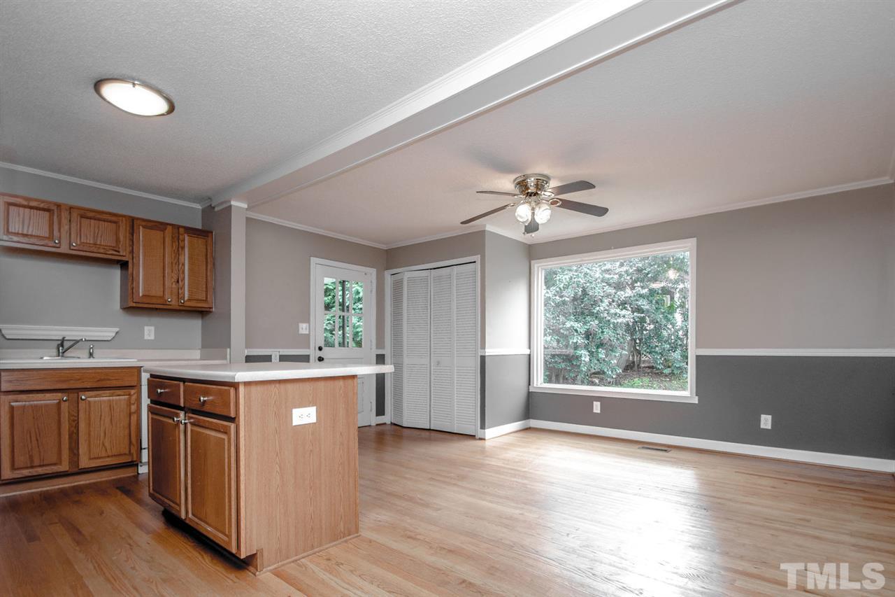 736 Mial Street Raleigh, NC 27608 - Photo 7 of 23 a kitchen with a stove a sink and a refrigerator