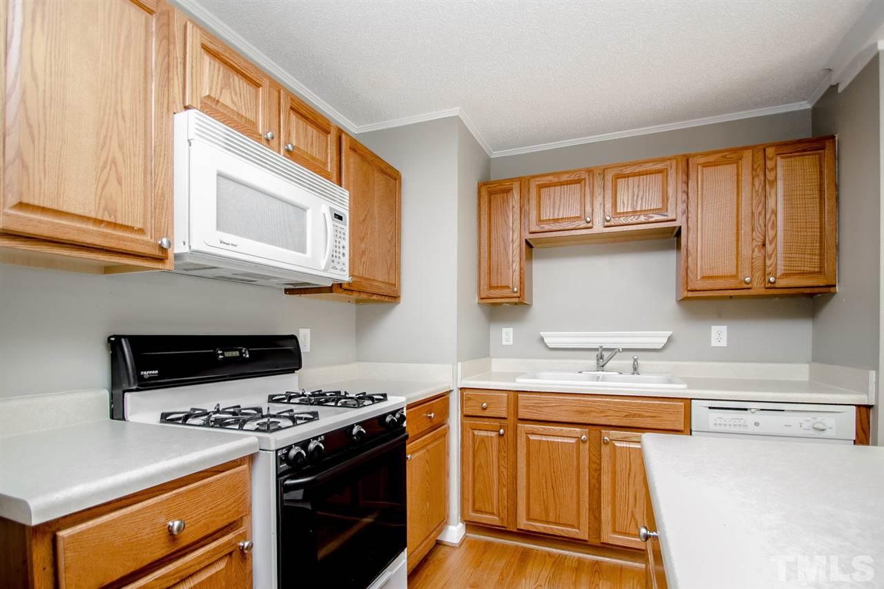 736 Mial Street Raleigh, NC 27608 - Photo 10 of 23 a kitchen with stainless steel appliances granite countertop a stove a sink and a microwave