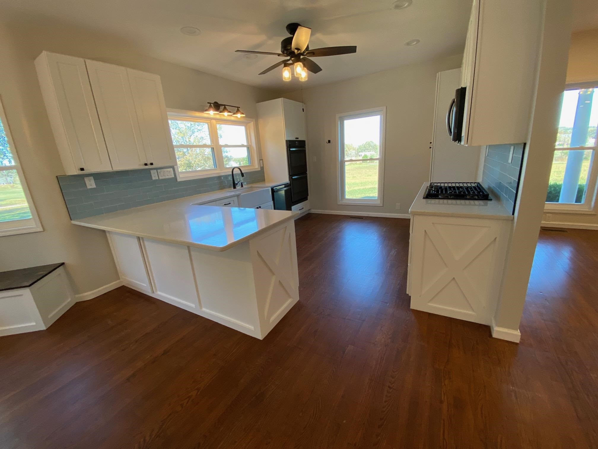 3650 Talley Store Road Henderson, TN 38340 - Photo 11 of 42 a living room with hard wood floors and a kitchen