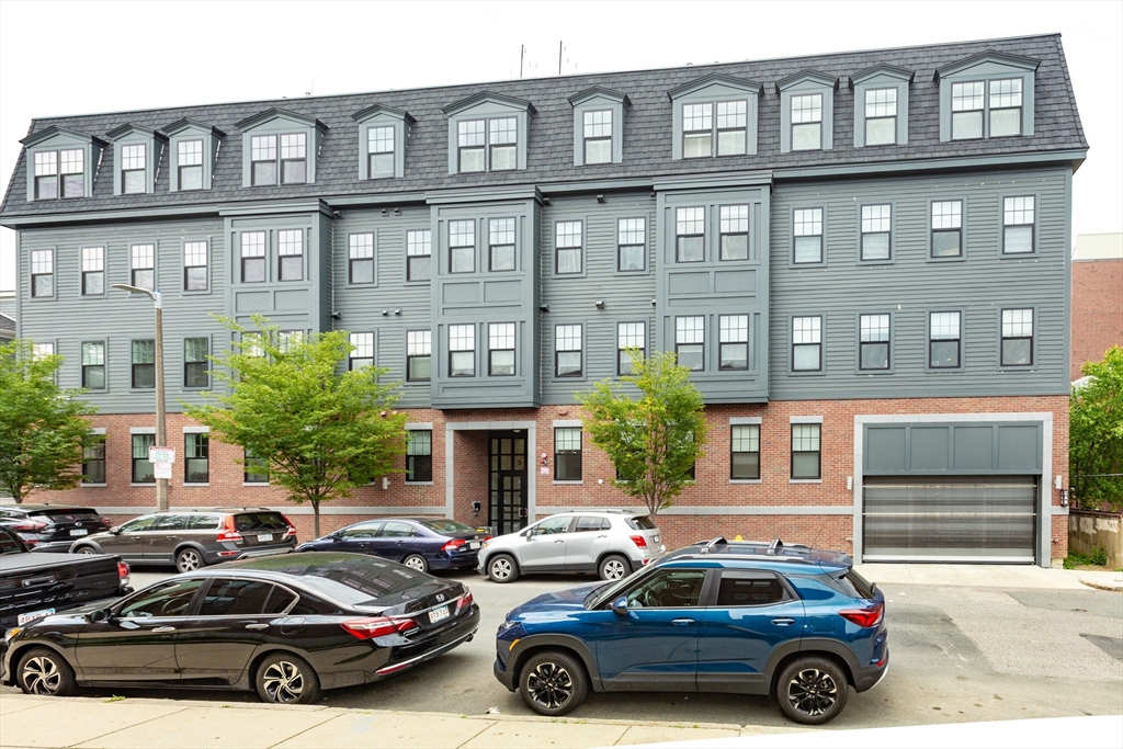 30 Polk Street, Unit 103 Boston, MA 02129 - Photo 1 of 20 a car parked in front of a building