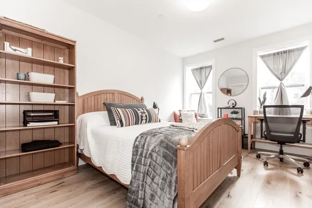 a bedroom with a bed next to a large window with the outer view