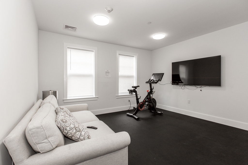 30 Polk Street, Unit 103 Boston, MA 02129 - Photo 17 of 20 a living room with furniture and a flat screen tv