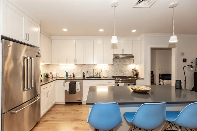 a kitchen with counter top appliances and cabinets