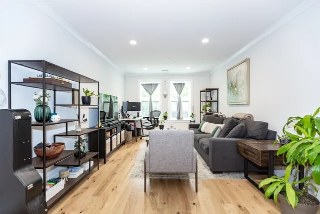 a living room with furniture and a wooden floor