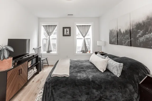 a bedroom with a bed and a flat screen tv