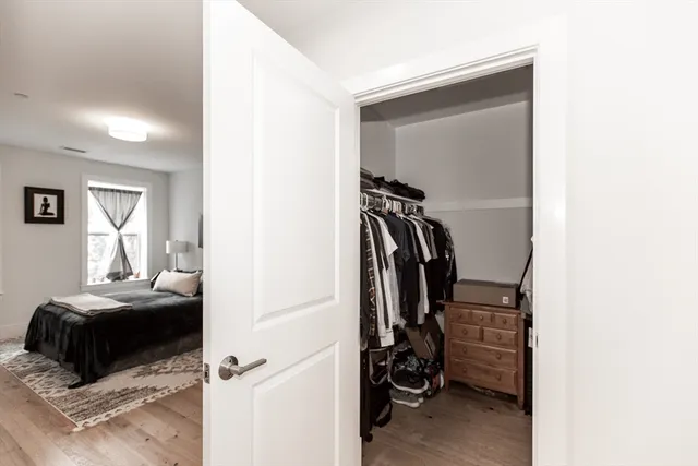 a view of walk in closet with clothes and shoes