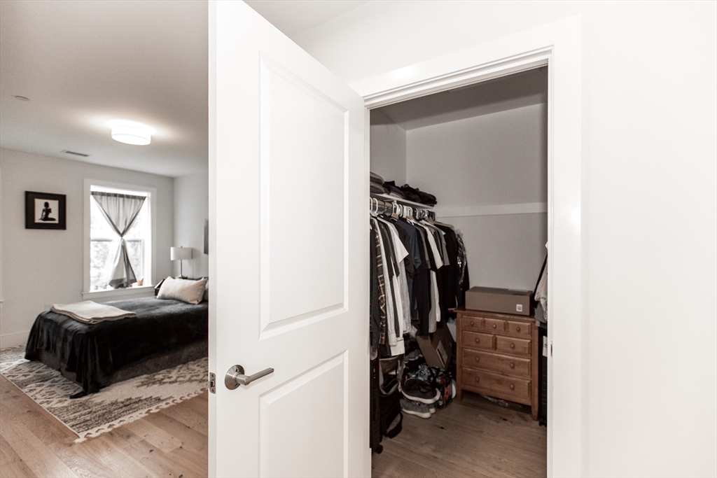 30 Polk Street, Unit 103 Boston, MA 02129 - Photo 9 of 20 a view of walk in closet with clothes and shoes