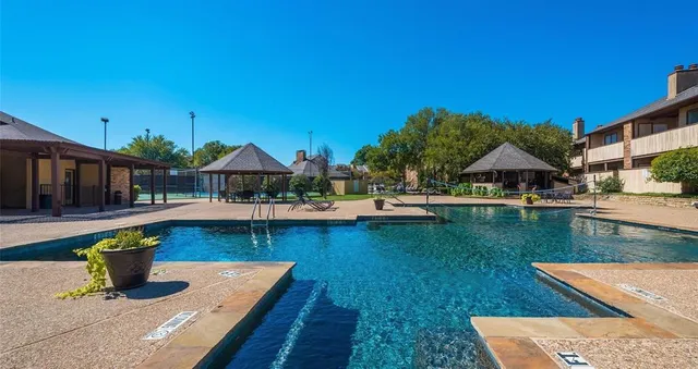 a view of house with swimming pool outdoor seating
