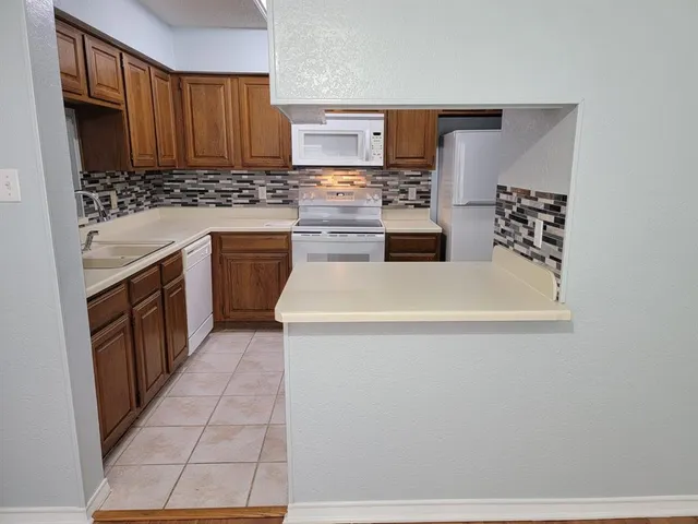 a kitchen with stainless steel appliances a stove a sink and a refrigerator