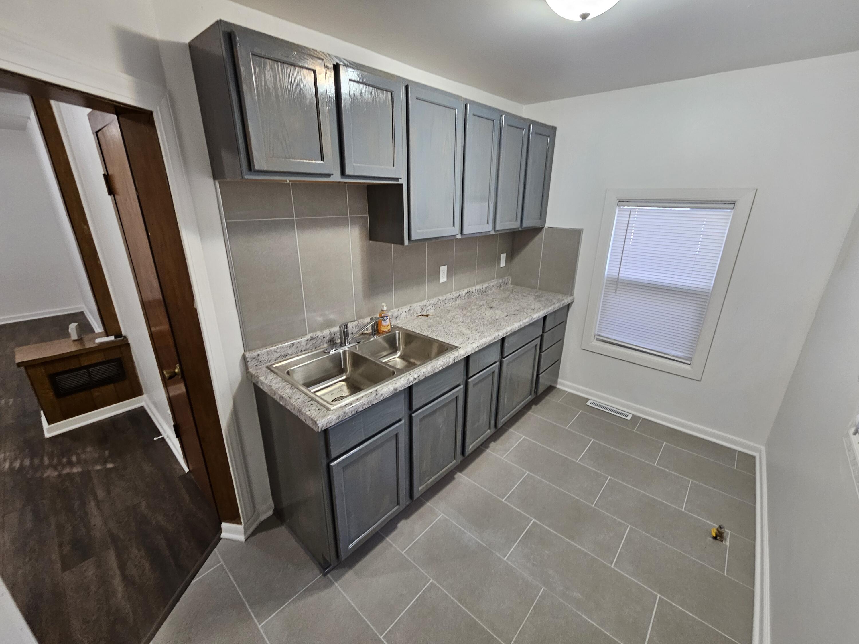 4471 Massachusetts Street Gary, IN 46409 - Photo 5 of 20 a kitchen with a stove refrigerator and microwave