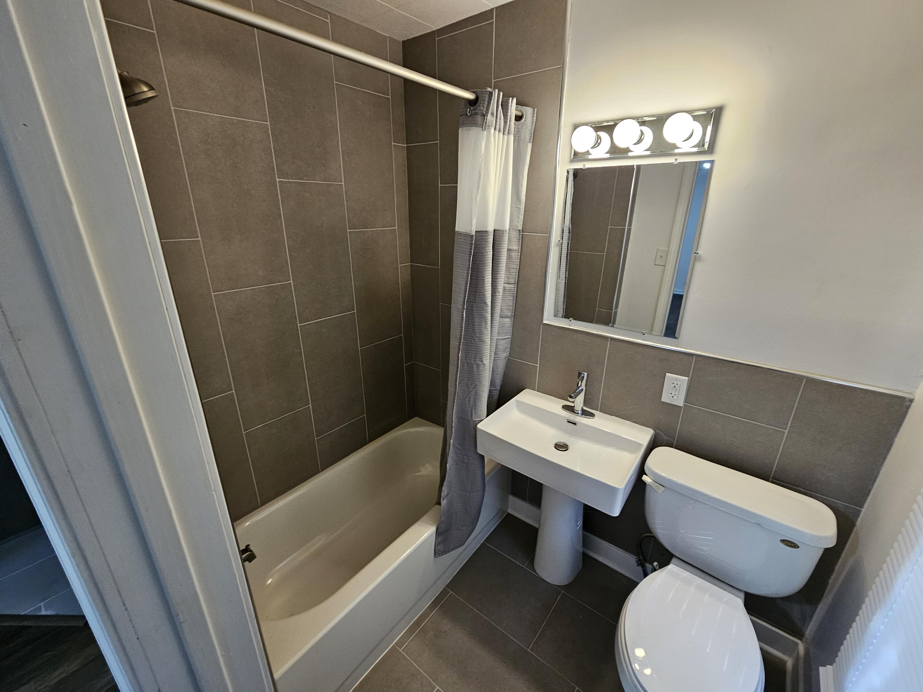 4471 Massachusetts Street Gary, IN 46409 - Photo 7 of 20 a bathroom with a sink a toilet and shower a mirror