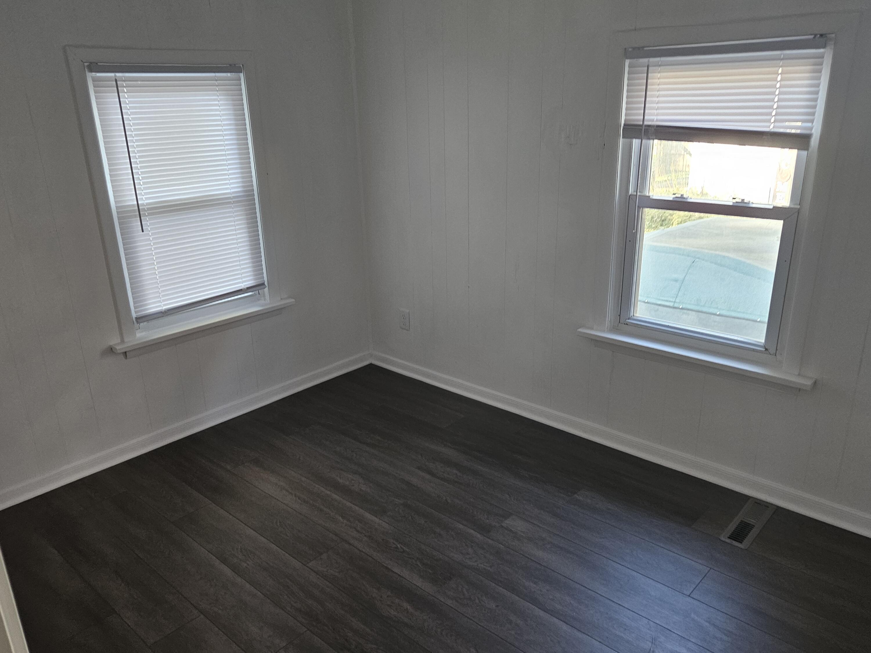 4471 Massachusetts Street Gary, IN 46409 - Photo 8 of 20 an empty room with wooden floor and windows