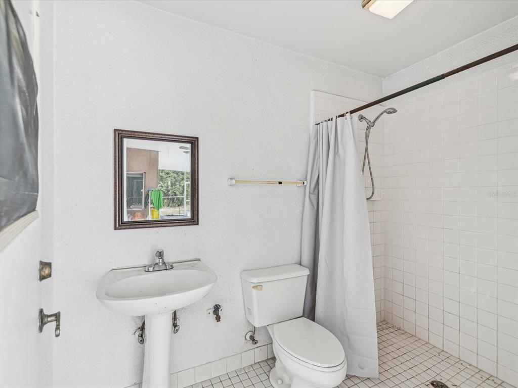 15420 Aubrey Avenue Spring Hill, FL 34610 - Photo 24 of 28 a bathroom with a sink a toilet and shower