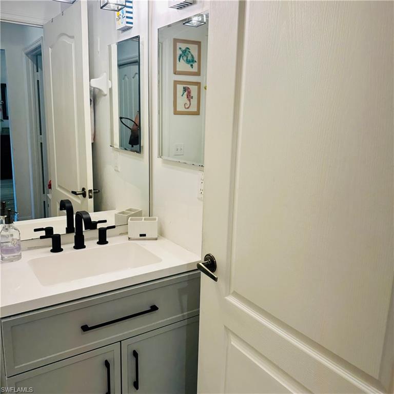 21300 Lancaster Run, Unit 926 Estero, FL 33928 - Photo 18 of 24 a bathroom with a sink and a mirror