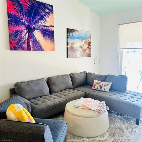 a living room with furniture and a white wall