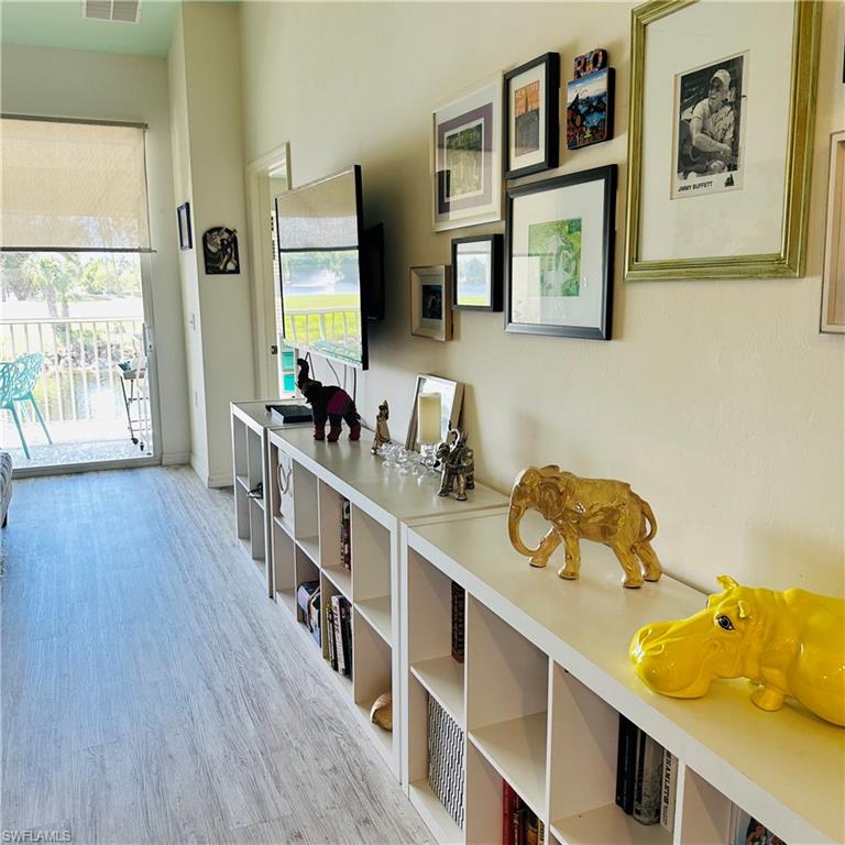 21300 Lancaster Run, Unit 926 Estero, FL 33928 - Photo 20 of 24 a hallway with a wooden floor and cabinets
