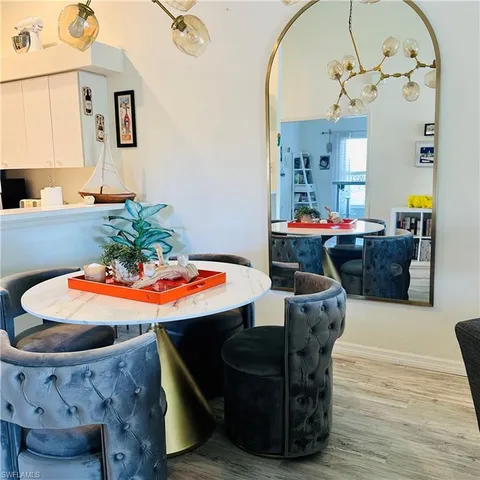 a dining room with furniture and wooden floor