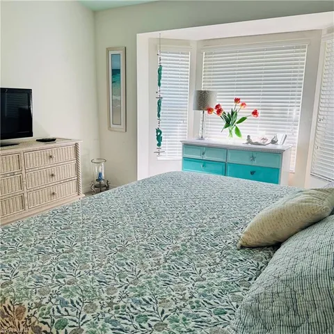 a bedroom with a bed and a television