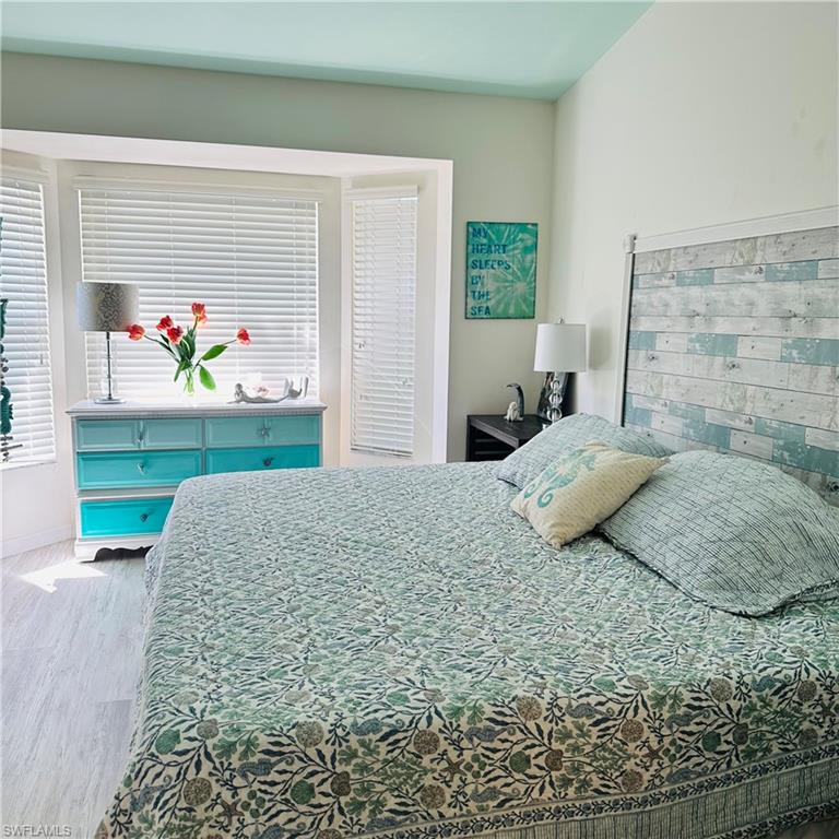 21300 Lancaster Run, Unit 926 Estero, FL 33928 - Photo 8 of 24 a bedroom with a bed table and window