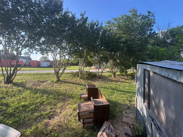 a backyard of a house with a yard and outdoor seating