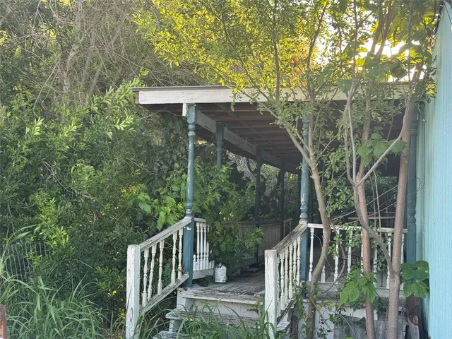 a view of backyard with green space and barbeque grill
