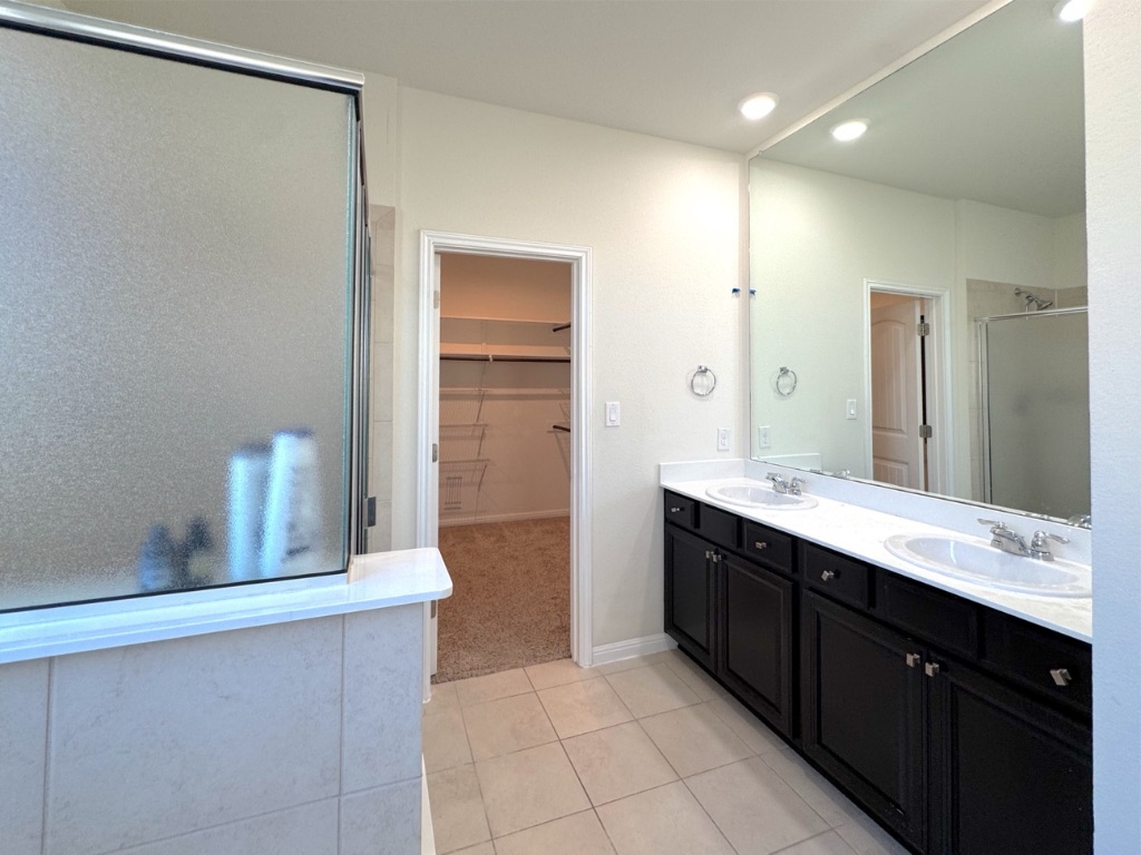 2056 Hat Bender Loop Round Rock, TX 78664 - Photo 15 of 27 a large bathroom with a double vanity sink and a mirror