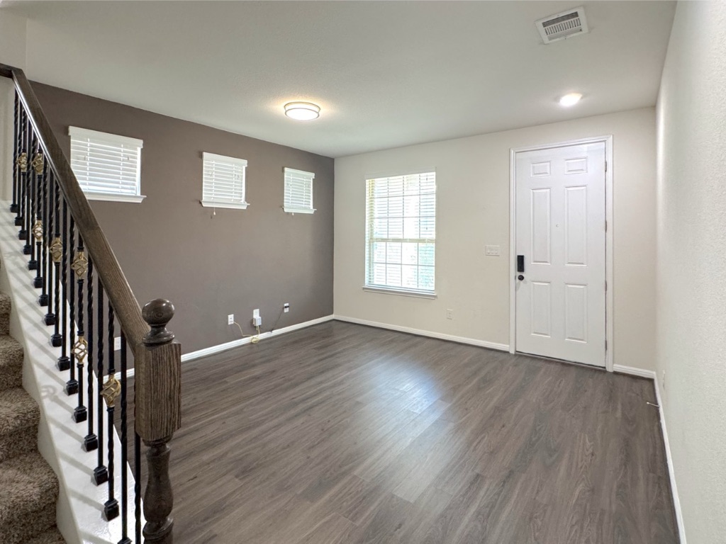 2056 Hat Bender Loop Round Rock, TX 78664 - Photo 4 of 27 a view of an empty room with wooden floor and a window